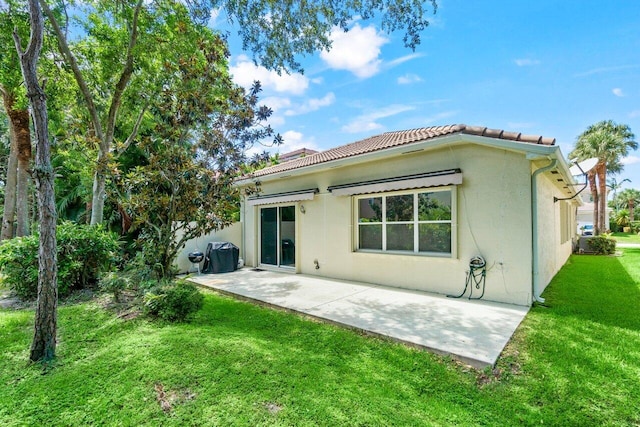 4086 Woodhill Pl, Boynton Beach, FL 33436 - rear view of house with a patio, a lawn, stucco siding, and a tile roof