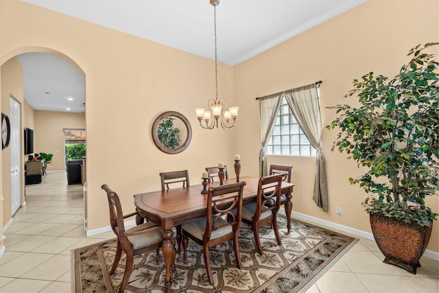 4086 Woodhill Pl, Boynton Beach, FL 33436 - dining space featuring arched walkways, light tile patterned flooring, and a chandelier