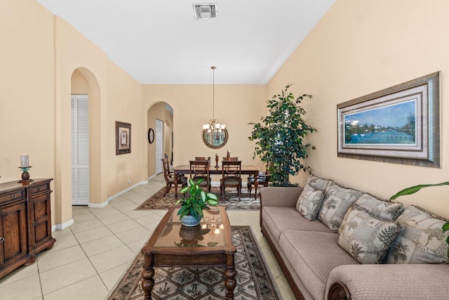 4086 Woodhill Pl, Boynton Beach, FL 33436 - living room featuring arched walkways, light tile patterned floors, and a chandelier