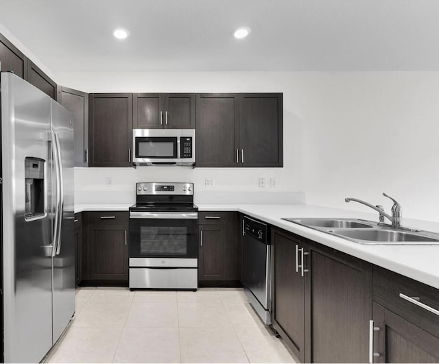 10606 W 33rd Ct, Hialeah, FL 33018 - kitchen featuring appliances with stainless steel finishes, light countertops, light tile patterned floors, dark brown cabinets, and recessed lighting