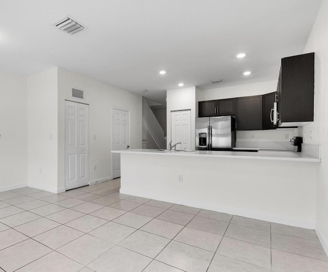 10606 W 33rd Ct, Hialeah, FL 33018 - kitchen featuring stainless steel fridge, recessed lighting, light countertops, light tile patterned floors, and a peninsula
