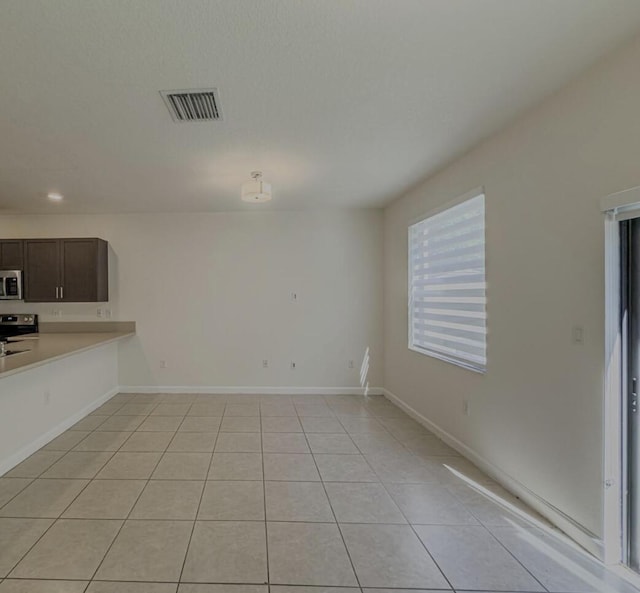 10606 W 33rd Ct, Hialeah, FL 33018 - unfurnished living room with light tile patterned flooring and recessed lighting