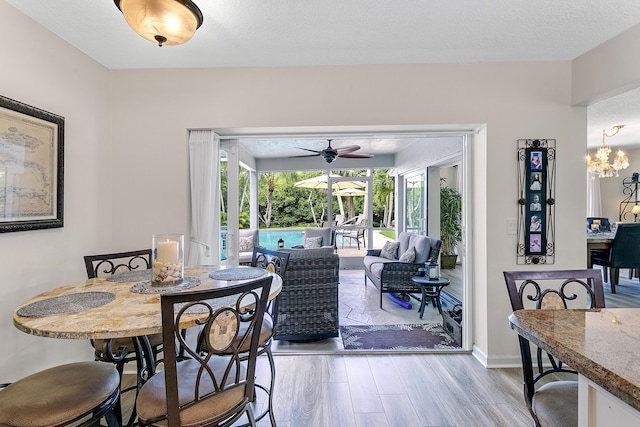 207 Jupiter Woods Dr, Jupiter, FL 33458 - dining space featuring wood finished floors, ceiling fan, and a chandelier