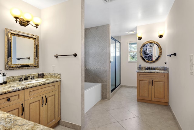 207 Jupiter Woods Dr, Jupiter, FL 33458 - full bathroom featuring a stall shower, two vanities, a bath, and tile patterned floors