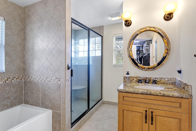 207 Jupiter Woods Dr, Jupiter, FL 33458 - bathroom with a stall shower, tile patterned flooring, a bath, vanity, and a walk in closet