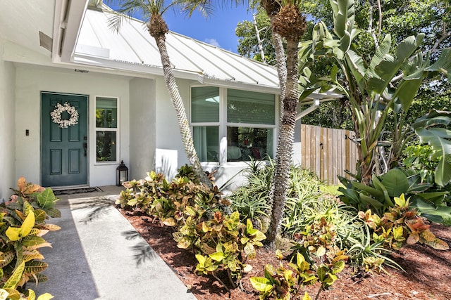 207 Jupiter Woods Dr, Jupiter, FL 33458 - property entrance featuring stucco siding, a standing seam roof, and a metal roof