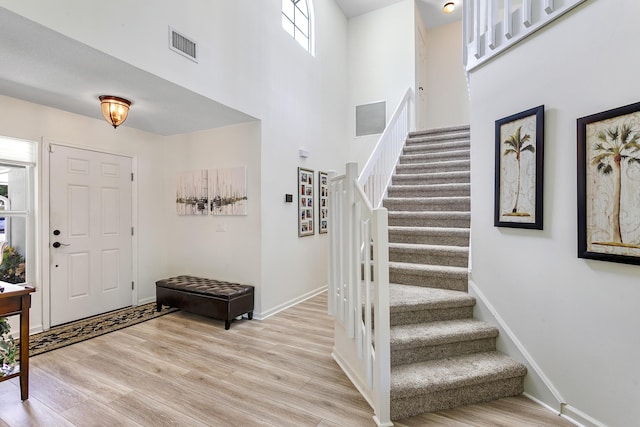 207 Jupiter Woods Dr, Jupiter, FL 33458 - entryway with stairway, light wood finished floors, and a high ceiling