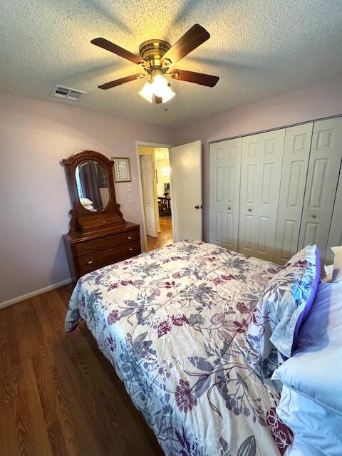 1023 Pheasant Run Dr Unit A, Fort Pierce, FL 34982 - bedroom with wood finished floors, a closet, a textured ceiling, and a ceiling fan