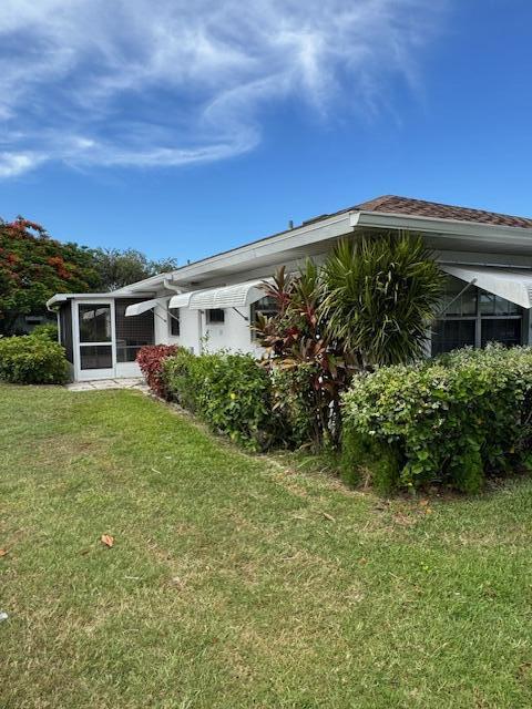 1023 Pheasant Run Dr Unit A, Fort Pierce, FL 34982 - rear view of property featuring a lawn
