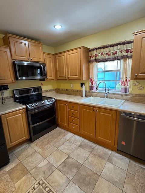1023 Pheasant Run Dr Unit A, Fort Pierce, FL 34982 - kitchen featuring stainless steel appliances, light countertops, brown cabinets, and recessed lighting