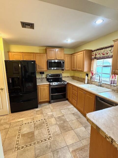 1023 Pheasant Run Dr Unit A, Fort Pierce, FL 34982 - kitchen featuring stainless steel appliances, light countertops, recessed lighting, and light tile patterned floors