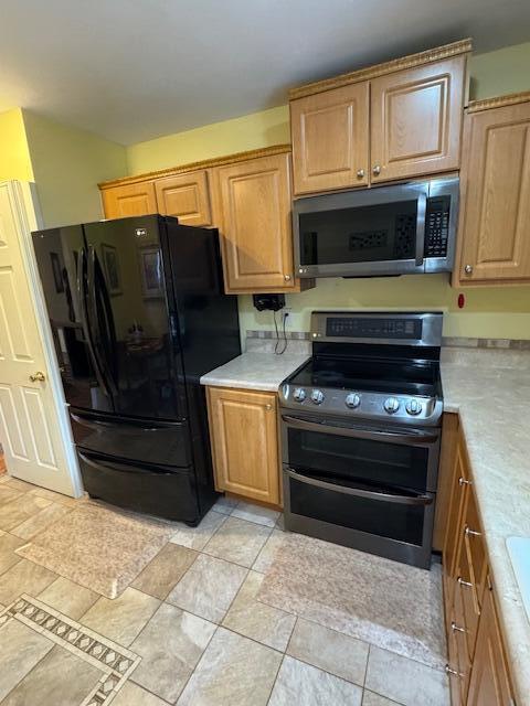 1023 Pheasant Run Dr Unit A, Fort Pierce, FL 34982 - kitchen featuring stainless steel appliances and light countertops