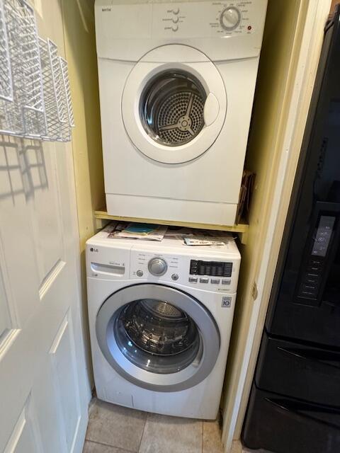 1023 Pheasant Run Dr Unit A, Fort Pierce, FL 34982 - washroom with stacked washer / dryer and light tile patterned floors