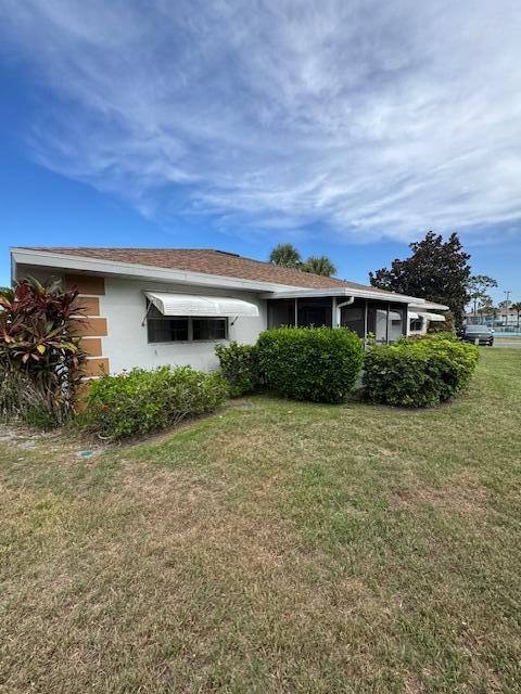 1023 Pheasant Run Dr Unit A, Fort Pierce, FL 34982 - view of property exterior featuring a yard