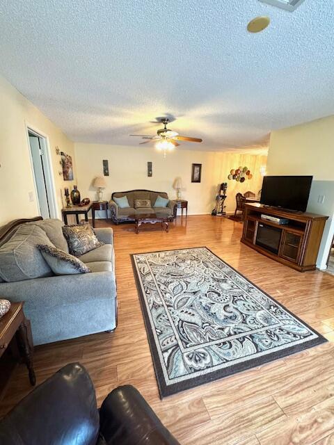 1023 Pheasant Run Dr Unit A, Fort Pierce, FL 34982 - living room with a ceiling fan, a textured ceiling, and wood finished floors