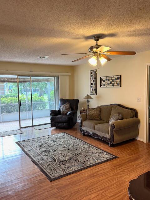 1023 Pheasant Run Dr Unit A, Fort Pierce, FL 34982 - living room featuring ceiling fan, a textured ceiling, and wood finished floors