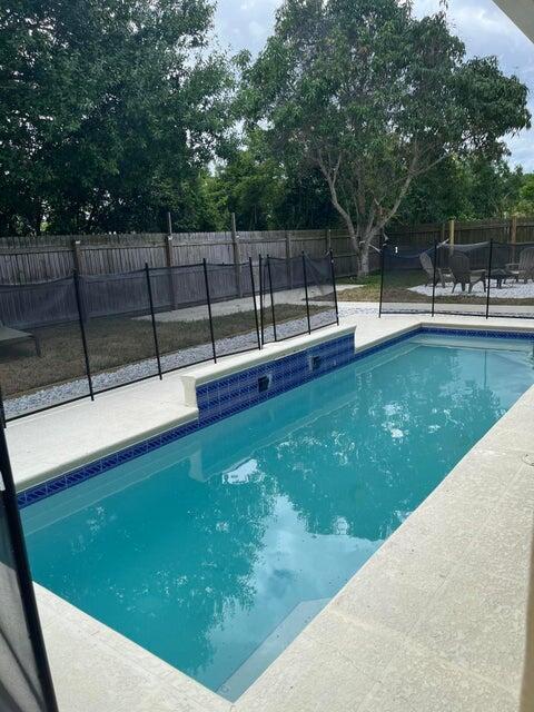3718 SW Masilunas St, Port Saint Lucie, FL 34953 - view of pool with a patio area and a fenced backyard
