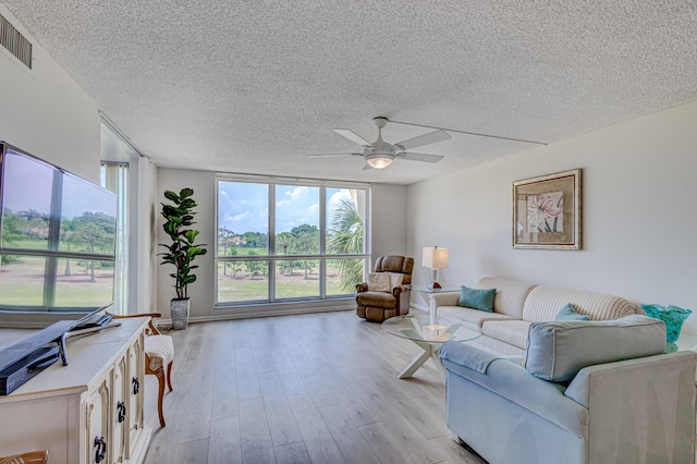 5390 Woodland Lakes Dr Unit 305, Palm Beach Gardens, FL 33418 - living area with a textured ceiling, plenty of natural light, a ceiling fan, and light wood finished floors