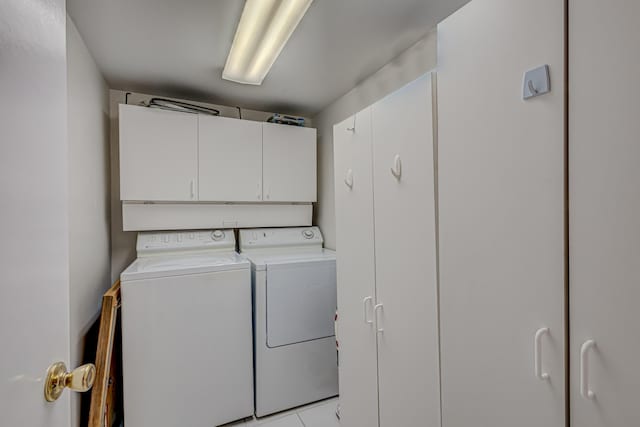5390 Woodland Lakes Dr Unit 305, Palm Beach Gardens, FL 33418 - washroom featuring cabinet space, separate washer and dryer, and light tile patterned floors