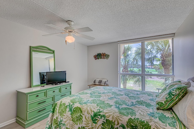 5390 Woodland Lakes Dr Unit 305, Palm Beach Gardens, FL 33418 - bedroom featuring a textured ceiling, light wood-style flooring, and a ceiling fan