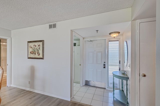 5390 Woodland Lakes Dr Unit 305, Palm Beach Gardens, FL 33418 - entrance foyer featuring light wood-type flooring and a textured ceiling