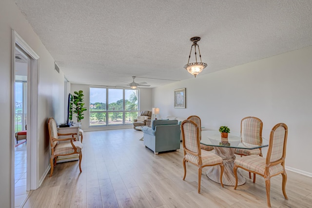 5390 Woodland Lakes Dr Unit 305, Palm Beach Gardens, FL 33418 - dining space featuring a textured ceiling, light wood-type flooring, and a ceiling fan