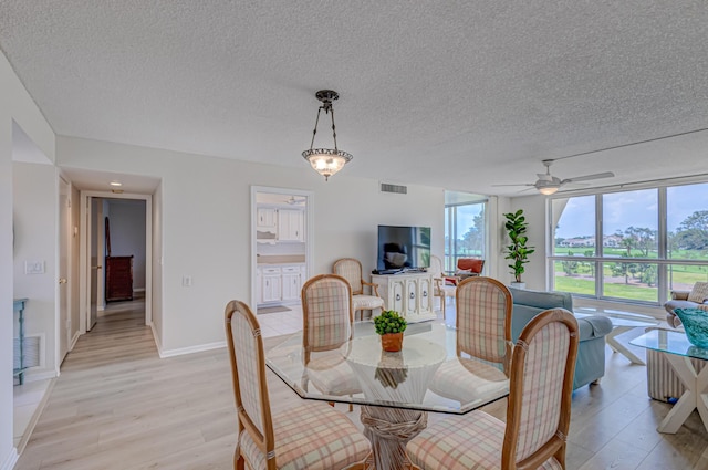 5390 Woodland Lakes Dr Unit 305, Palm Beach Gardens, FL 33418 - dining area featuring light wood-type flooring, a textured ceiling, and ceiling fan