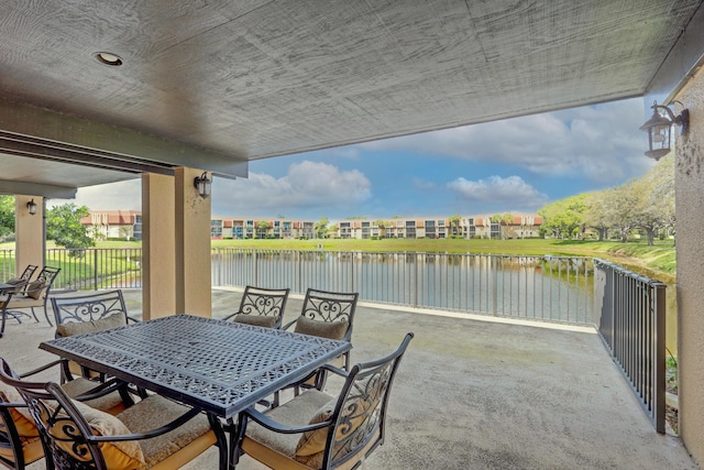 5390 Woodland Lakes Dr Unit 305, Palm Beach Gardens, FL 33418 - view of patio with outdoor dining space and a water view