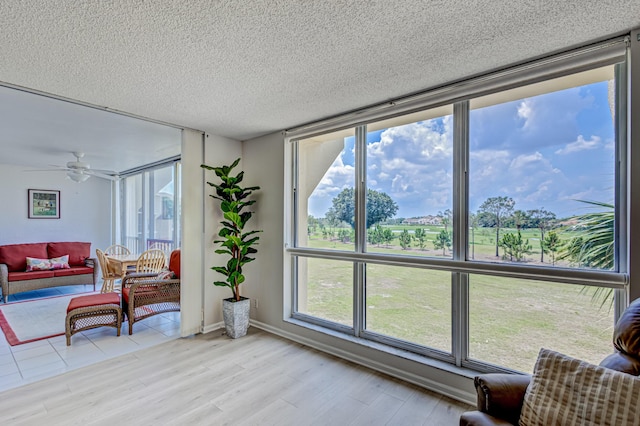 5390 Woodland Lakes Dr Unit 305, Palm Beach Gardens, FL 33418 - living area featuring plenty of natural light, wood finished floors, ceiling fan, and a textured ceiling