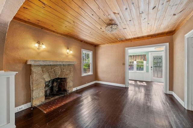 909 N L St, Lake Worth Beach, FL 33460 - unfurnished living room featuring wood ceiling, wood-type flooring, a stone fireplace, and plenty of natural light