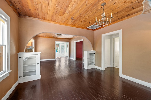 909 N L St, Lake Worth Beach, FL 33460 - unfurnished living room featuring arched walkways, wood ceiling, a chandelier, and hardwood / wood-style flooring