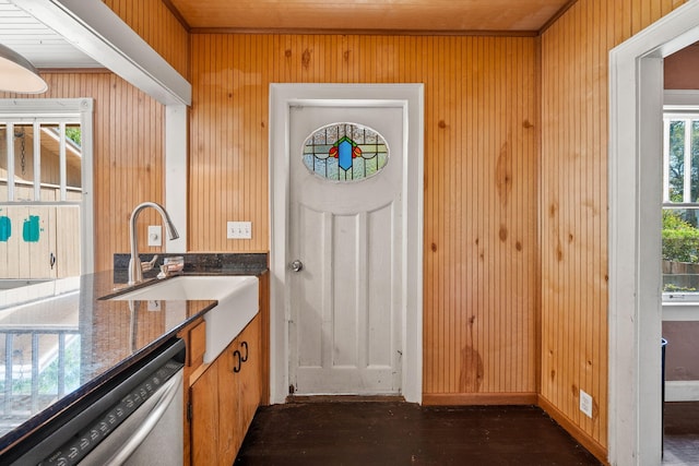 909 N L St, Lake Worth Beach, FL 33460 - kitchen featuring stainless steel dishwasher, dark stone counters, and wood walls