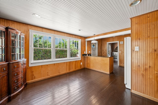 909 N L St, Lake Worth Beach, FL 33460 - kitchen featuring wooden walls, freestanding refrigerator, dark wood finished floors, a peninsula, and pendant lighting