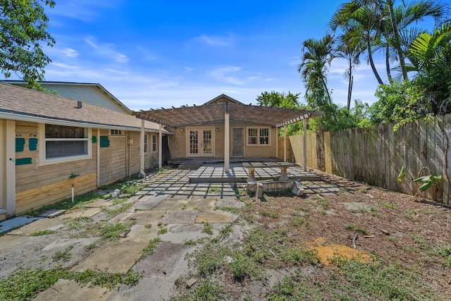 909 N L St, Lake Worth Beach, FL 33460 - rear view of property with a pergola, a fenced backyard, a patio area, and french doors