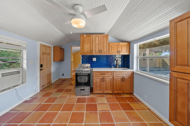 909 N L St, Lake Worth Beach, FL 33460 - kitchen featuring lofted ceiling, stainless steel stove, light tile patterned flooring, light countertops, and tasteful backsplash