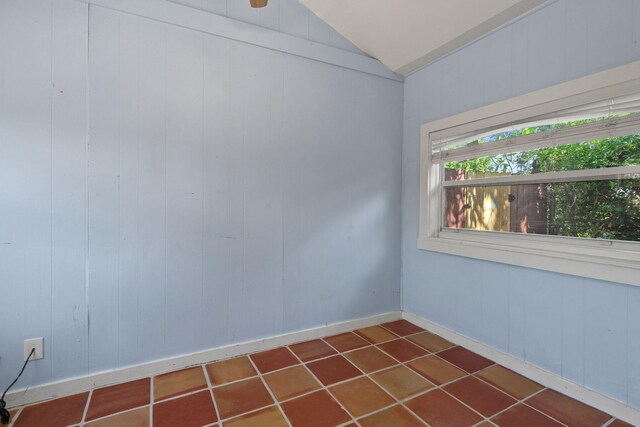 909 N L St, Lake Worth Beach, FL 33460 - spare room with vaulted ceiling and dark tile patterned flooring