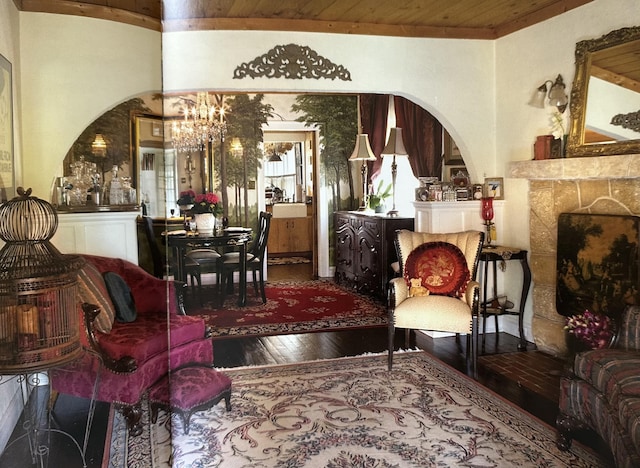 909 N L St, Lake Worth Beach, FL 33460 - sitting room with arched walkways, a chandelier, wood-type flooring, wooden ceiling, and a fireplace