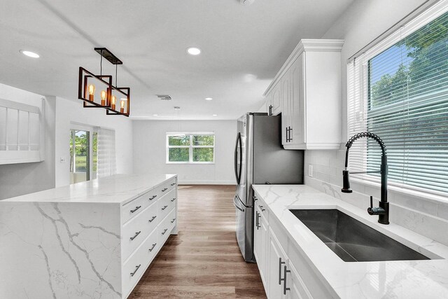 4110 NW 10th St, Delray Beach, FL 33445 - kitchen with white cabinetry, recessed lighting, freestanding refrigerator, light stone countertops, and dark wood finished floors