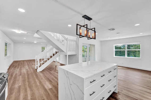 4110 NW 10th St, Delray Beach, FL 33445 - kitchen with healthy amount of natural light, wood finished floors, recessed lighting, and a kitchen island