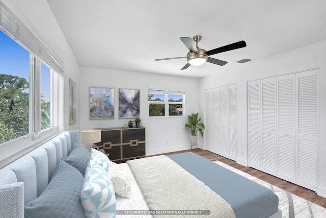 4110 NW 10th St, Delray Beach, FL 33445 - bedroom featuring wood finished floors, a ceiling fan, and multiple closets