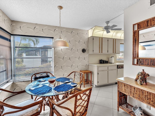 5869 Sugar Palm A Ct Unit A, Delray Beach, FL 33484 - dining area with ceiling fan, wallpapered walls, a textured ceiling, and light tile patterned floors