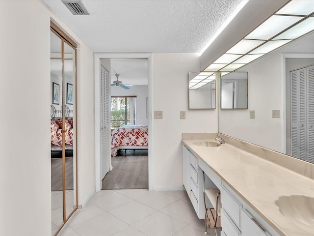 5869 Sugar Palm A Ct Unit A, Delray Beach, FL 33484 - ensuite bathroom with double vanity, tile patterned flooring, a closet, a textured ceiling, and ceiling fan