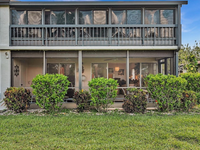 5869 Sugar Palm A Ct Unit A, Delray Beach, FL 33484 - rear view of house featuring a balcony, a lawn, a ceiling fan, and a sunroom