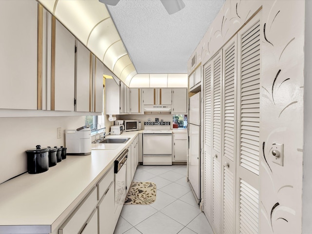 5869 Sugar Palm A Ct Unit A, Delray Beach, FL 33484 - kitchen with white appliances, under cabinet range hood, light countertops, light tile patterned floors, and a textured ceiling