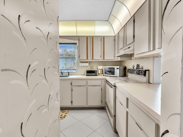 5869 Sugar Palm A Ct Unit A, Delray Beach, FL 33484 - kitchen with white appliances, light countertops, under cabinet range hood, and light tile patterned flooring