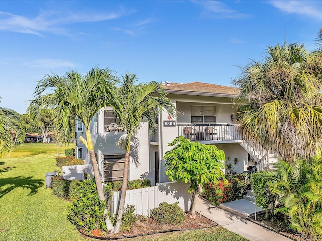 5869 Sugar Palm A Ct Unit A, Delray Beach, FL 33484 - view of front of home with stucco siding, stairs, a front yard, and a balcony