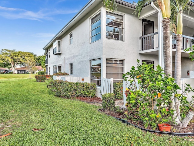5869 Sugar Palm A Ct Unit A, Delray Beach, FL 33484 - view of side of home featuring stucco siding and a lawn
