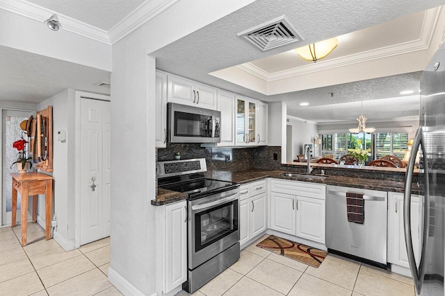6662 Boca Del Mar Dr Unit 118, Boca Raton, FL 33433 - kitchen featuring stainless steel appliances, a textured ceiling, light tile patterned flooring, ornamental molding, and white cabinetry