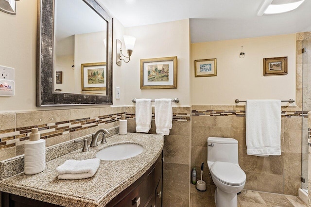 6662 Boca Del Mar Dr Unit 118, Boca Raton, FL 33433 - bathroom featuring tile walls, vanity, tiled shower, wainscoting, and tile patterned floors