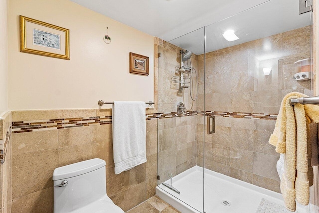 6662 Boca Del Mar Dr Unit 118, Boca Raton, FL 33433 - bathroom with tile walls, a stall shower, and a wainscoted wall